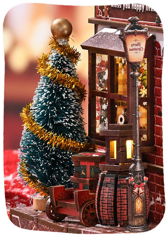 Mini Christmas tree in gold tinsel beside the street lamp